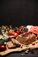 Obraz na płótnie Canvas Traditional French terrine covered with bacon on dark wooden background with Christmas decorations