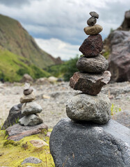 Pyramid of stones on the backdrop of mountains in the Elbrus region. Balance, meditation and stability concept
