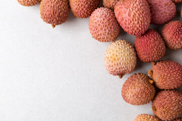 Fresh lychee fruit on grey background. Copy space