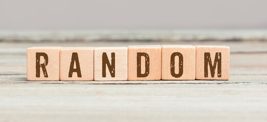 Random as word on cubes on wood table