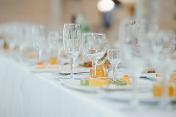 beautifully laid tables with glasses and appliances at morning in restaurant