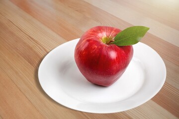 Fresh sweet ripe apple on the desk