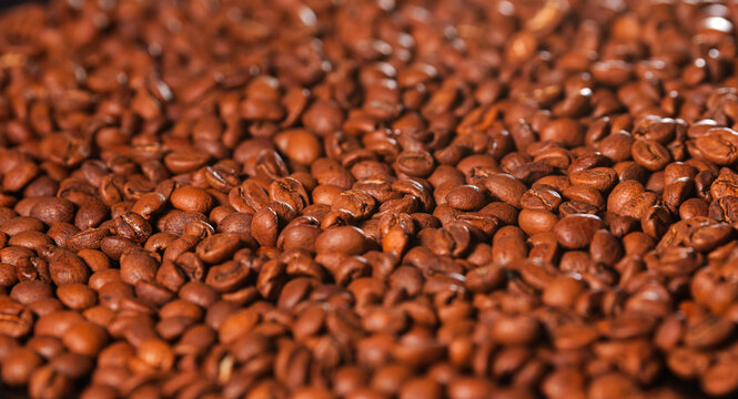 Roasted coffee beans texture. Close up view with a lot of coffee, image that can be used as background.