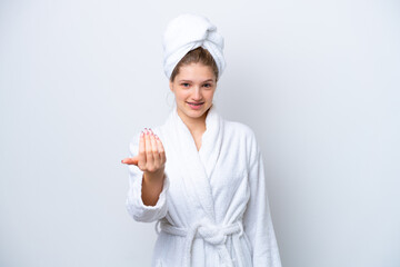 Teenager Russian girl in a bathrobe isolated on white background inviting to come with hand. Happy that you came