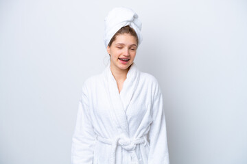 Teenager Russian girl in a bathrobe isolated on white background laughing