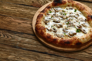 Appetizing pizza with mushrooms on a wooden tray