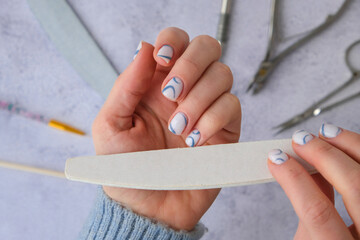 Professional stylish trendy blue Hardware Manicure. Procedure for the preparation of nails. Cuticle...