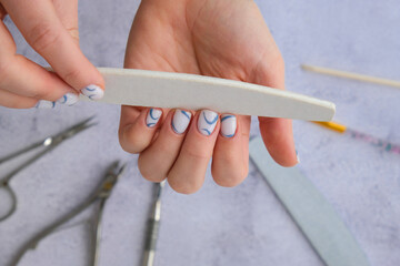 Professional stylish trendy blue Hardware Manicure. Procedure for the preparation of nails. Cuticle...