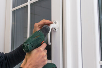 Professional handyman installing window at home.