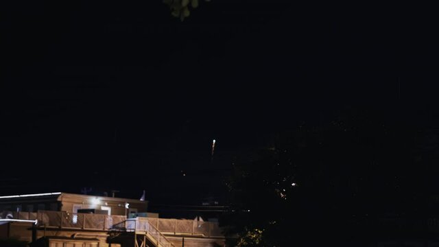 4th of July fireworks being shot over neighborhood at night, 4K