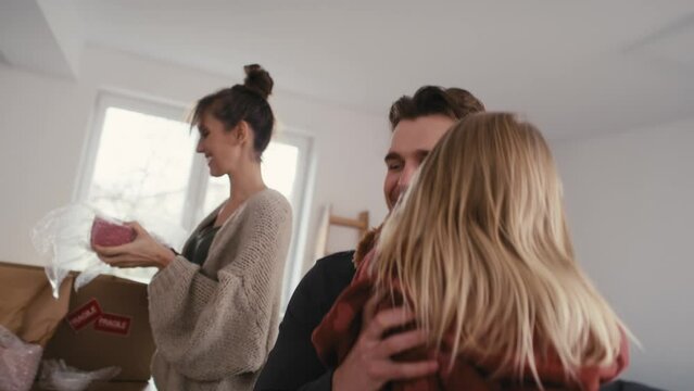 Caucasian family packing kitchen stuff in new house. Shot with RED helium camera in 8K.