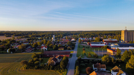 Aerial panorama of Swedish countryside, Swedish village at sunrise, clear blue sky, green yellow...