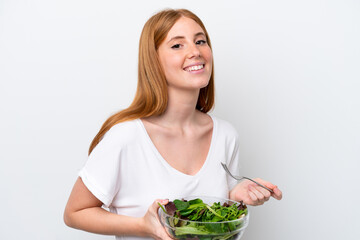 Young redhead woman isolated on white background holding a bowl of salad with happy expression