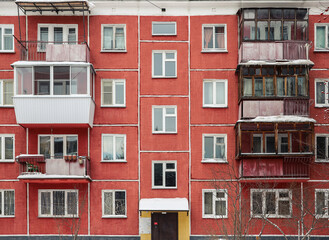 The red green panel house. With trees