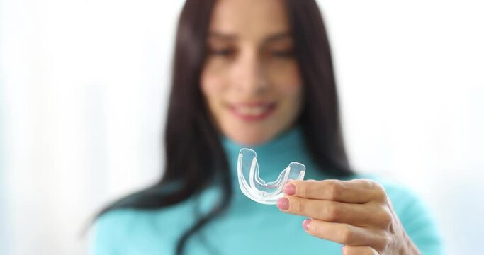 Woman is holding plastic mouth guard slow motion 4k movie