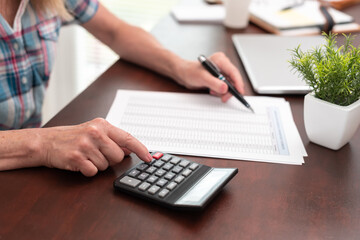 Female hands making calculation