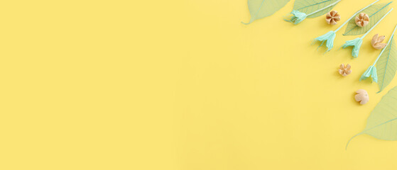 Top view image of forest natural composition over yellow background .Flat lay