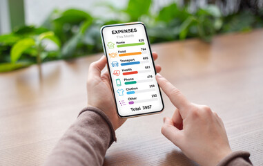 Woman checking her montly expenses while having coffee break