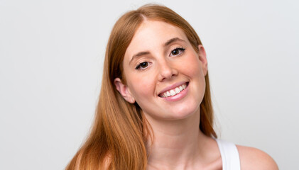 Naklejka premium Portrait of pretty redhead woman over isolated white background