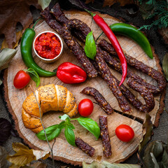 sausages on a wooden board of tree trunk