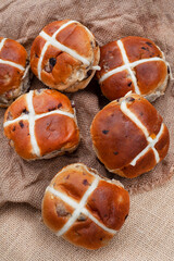 fresh and tasty traditional hot cross buns on rustic surface