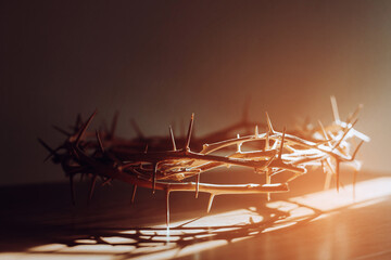 the crown of thorns of Jesus on the table in the dark room against  window light with copy space, can be used for Christian background, Easter concept