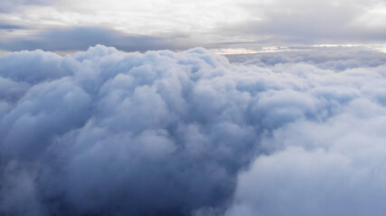 Fototapeta premium Amazing Aerial Shot: Drone Flying Over Fluffy Blue and White Clouds.
