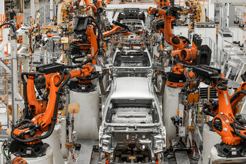 Photo of automobile production line. Modern car assembly plant. Modern and high-tech automotive industry