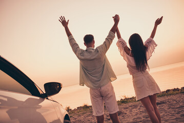 Back rear view photo of young couple enjoy date honeymoon vacation seaside car freedom hold hands summer outdoors