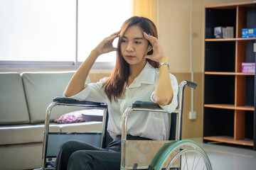 Young woman patient with a worried expression in a wheelchair in the hospital.
