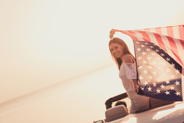 Profile side photo of young girl cabriolet good mood hold american flag journey 4-july citizen...