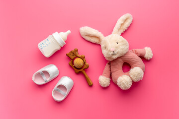 Baby girl pink shoes with milk and toy. Newborn set background