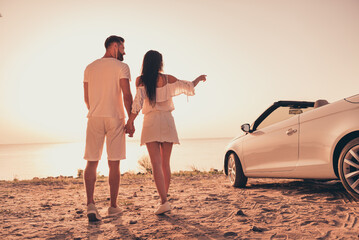 Back rear view full body photo of young couple seaside journey car transport point indicate finger...