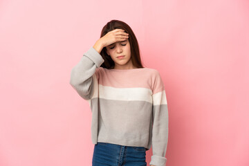 Little girl isolated on pink background with headache