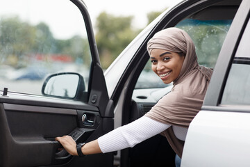 Fototapeta premium Woman driving her car, study on street. Transport concept, driving lesson in city