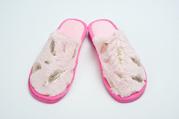 Women's room slippers with faux fur and pink soles.