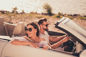 Photo of cheerful young couple rider cabriolet enjoy sunny weather sightseeing travel abroad outdoors - obrazy, fototapety, plakaty