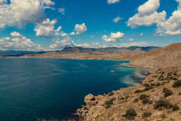 Seascape from the top of the mountains. The nature of the sea. Clouds, sea, mountains. A sunny day. Horizontal photo. Vacation, travel. Concept: calendar, cover.