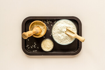 Pestle rice flour - grains with mortar on kitchen table