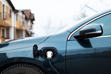 Close-up of power cable of electric car on charging station.