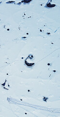 Aerial view of the snowy texture of a frozen lake in winter. North Pole and ice