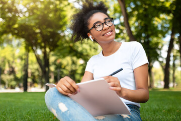 Smiling Black Studet Girl Sketching Learning Sitting In Park Outside