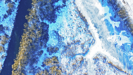 Aerial view of the texture of frozen wildlife in winter. Photo of ice and snowy river from above