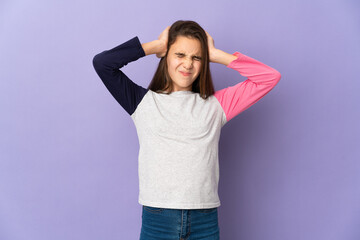 Little girl isolated on purple background frustrated and covering ears