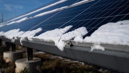 Fototapeta premium snow melting in photovoltaics - energy from the sun