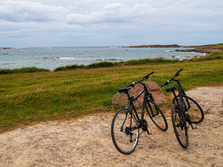 two bicycles on the sand near the coast in Brittany, France