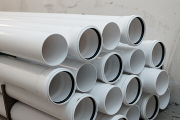White pipes with rubber sealing rings. PVC tube pipe,Plastic pipe or polypropylene or polyethylene,...