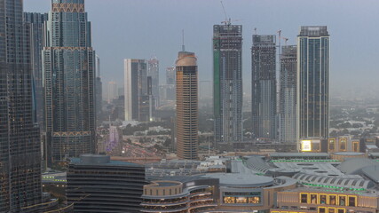 Fototapeta na wymiar Dubai downtown near fountains and modern futuristic architecture aerial day to night timelapse