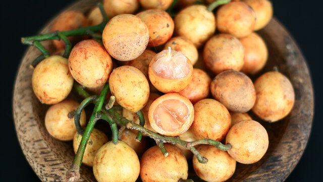 Menteng fruit or Baccaurea racemosa on wood plate. 