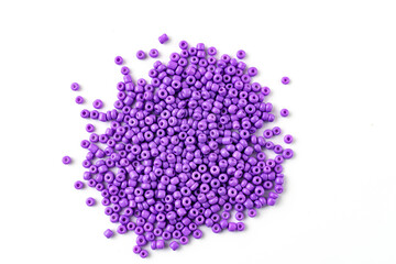 purple beads are scattered on a white surface. isolate. sale of accessories for creativity and needlework.